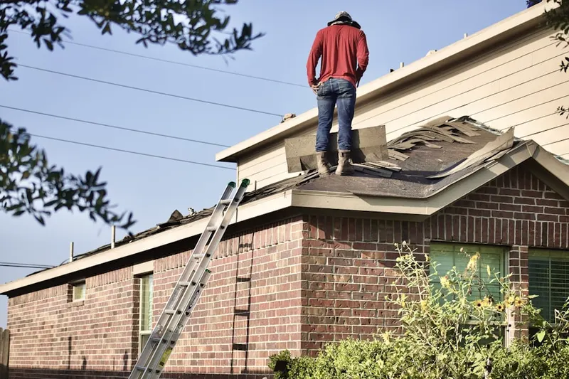 Professional roofer working on a residential roof in Fort Carson